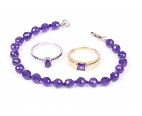 A 9ct gold and amethyst ring Together with, an amethyst faceted bead bracelet and an amethyst and silver ring (3) weight of g