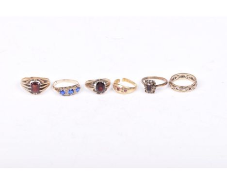 Two Gents garnet ringsBoth to yellow metal settings, stamped 9ct, together with, a blue paste three stone ring to yellow meta