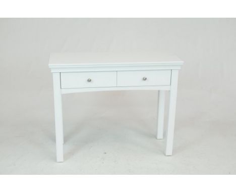 A modern white console or hall tableThe rectangular moulded top above two frieze drawers each with brush metal button handles