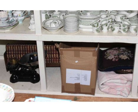 Scales with weights, linens, punch books on book shelf stand and two fur coats.