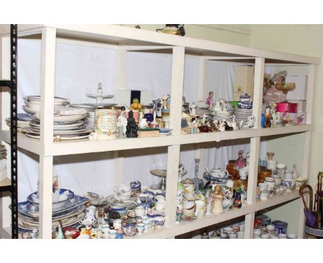 Two full shelf lots of porcelain including figurines, plates, Hornsea Saffron lidded jars, dolls, lamp, umbrella stand, etc.
