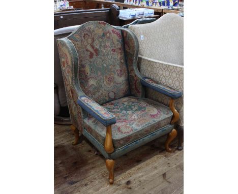 Tapestry wing open armchair on cabriole legs.