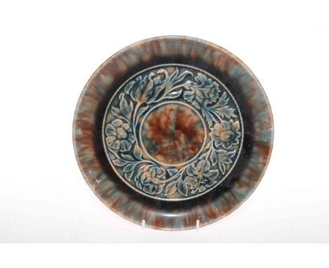 Linthorpe Pottery plate with moulded band of foliage, shape no. 924, Henry Tooth monogram, 25.5cm diameter.