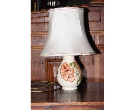 Moorcroft Pottery table lamp decorated with hibiscus on ivory ground.