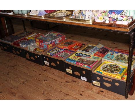 Six boxes of vintage jigsaw puzzles.