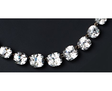 A PASTE RIVIÈRE NECKLACE, claw set with a line of graduated cushion-shaped white pastes, with later extension chain, 41cm lon