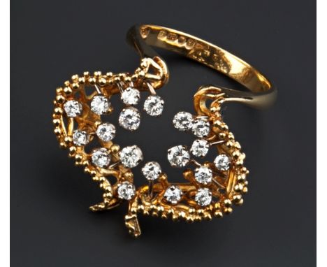 AN 18CT GOLD AND DIAMOND SET DRESS RING BY JOHN DONALD, the shaped beaded surround issuing spokes of graduated length, each t