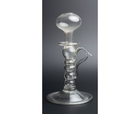 AN 18TH CENTURY GLASS LACE MAKER'S LAMP with shaped handle and domed base, 25.2cm high