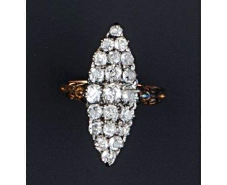 A NAVETTE-SHAPED DIAMOND PANEL RING, set with graduated old and cushion-cut diamonds, between scroll engraved shoulders, the 