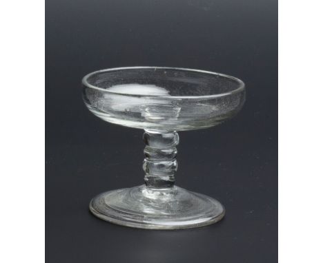 A SMALL GLASS PATCH STAND with dished top on lobed tapering column and folded foot, 5.3cm high