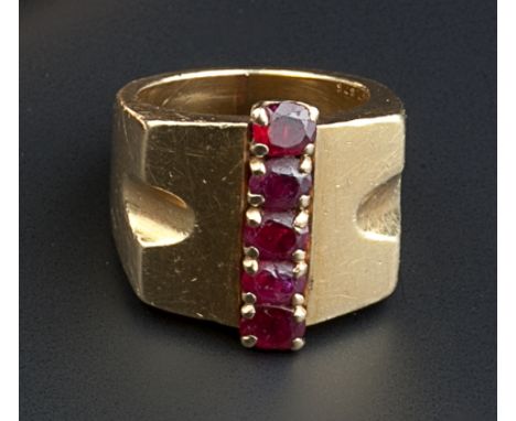 A RUBY SET DRESS RING BY VAN CLEEF & ARPELS, circa 1940, the tapered geometric panel centred with a line of oval mixed-cut ru