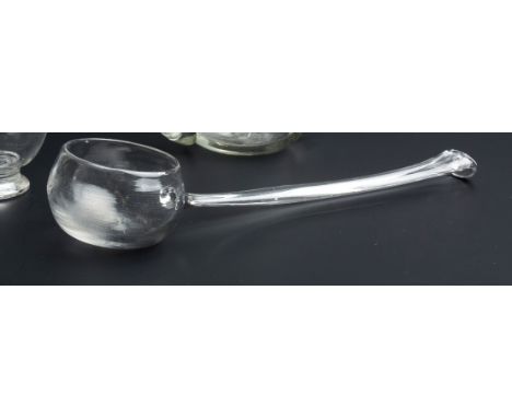 AN EARLY 18TH CENTURY GLASS PUNCH LADLE, 28cm long