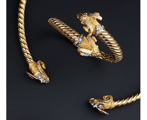 A DIAMOND AND RUBY SET RAM'S HEAD SUITE, comprising a hinged torque collar necklace, a hinged crossover bangle, a crossover r