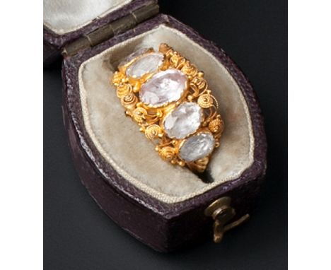 A 19TH CENTURY TOPAZ FIVE STONE RING, the graduated oval-cut topaz in foiled closed-back settings, to tapered ropetwist wirew