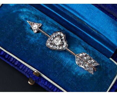 A DIAMOND SET ARROW AND HEART BROOCH, highlighted with graduated old and lasque-cut diamonds, with later fitting, cased, 5.3c