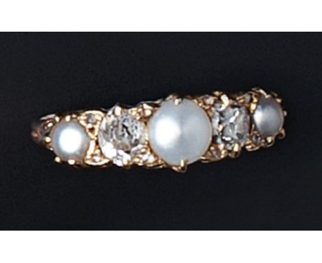 A HALF PEARL AND DIAMOND FIVE STONE RING, the scroll engraved hoop alternately set with graduated half pearls and old-cut dia