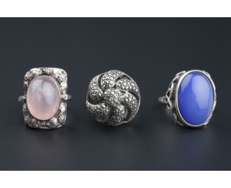 THREE GEM SET DRESS RINGS, comprising an Arts and Crafts style rose quartz cabochon ring, ring size P, a further cabochon set