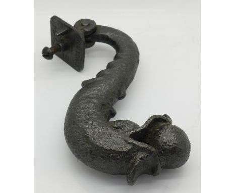 A cast iron dolphin door knocker, marked 'made in England'