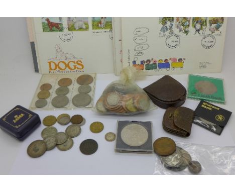 A collection of coins including a George III crown and a 1900 US half-dollar and fourteen stamp first day covers including 19