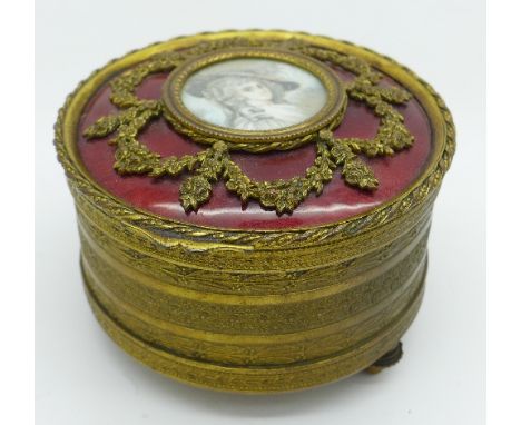 A gilt metal musical trinket box with portrait, one foot a/f