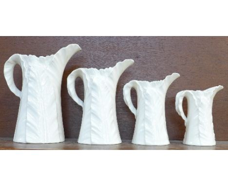 A set of four graduated Royal Worcester cream porcelain jugs, small chip to the rim of second smallest