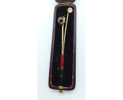 A yellow metal, cabochon garnet and diamond stick pin and a 9ct gold and white stone stick pin