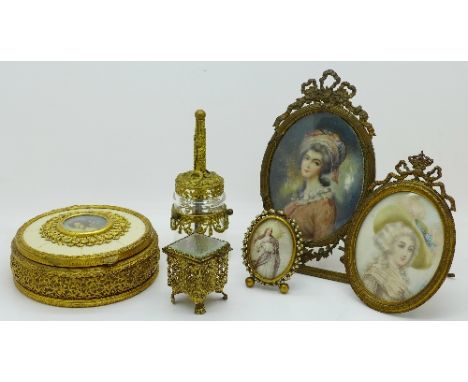 A circular trinket box with portrait, two framed oval portraits, a small oval frame, a small trinket box and a bell shaped gi