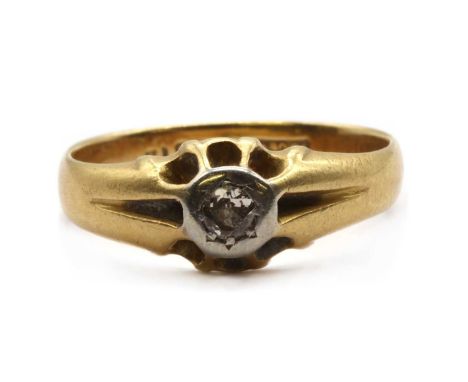 A gold single stone diamond ring, an old Swiss cut diamond, grain set to an illusion collet, to reeded shoulders and a plain 