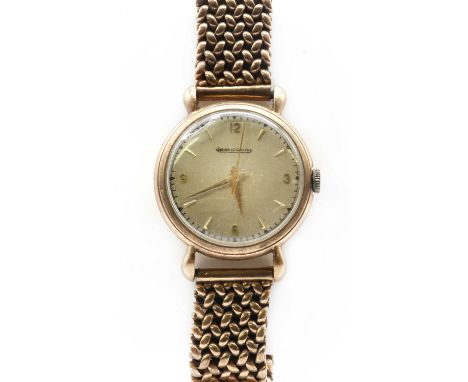 A 9ct gold Jaeger-LeCoultre mechanical bracelet watch,33mm diameter with a silvered dial, baton markers with Arabic numerals 