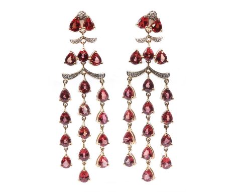 A pair of 9ct gold ruby and diamond drop earrings,three drops composed of a series of pear mixed cut rubies, claw set to arti