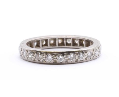 A white gold diamond full eternity ring, brilliant cut diamonds, grain set to hand engraved guards, tested as approximately 1