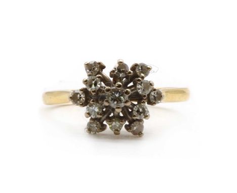 An 18ct gold diamond cluster ring,a cluster of brilliant cut and eight cut diamonds, claw set in white to a wire gallery, to 