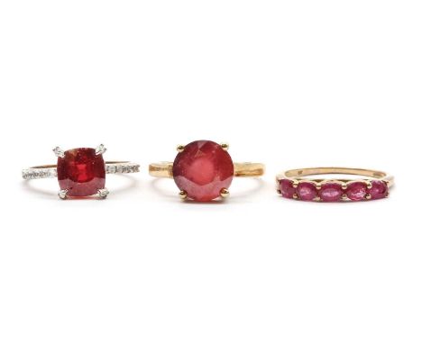 Three 9ct gold rings,comprising a single stone fracture filled ruby ring, a five stone fracture filled ruby ring, and a cushi