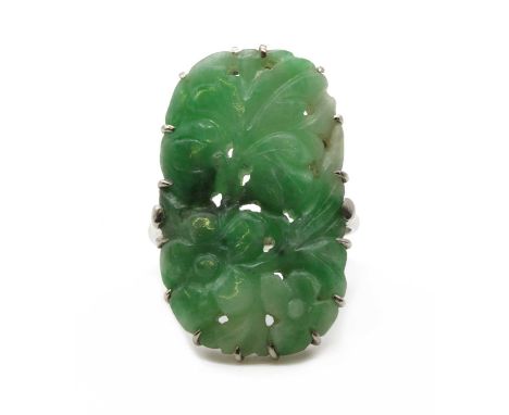 A white gold jade plaque ring, a pierced and carved floral jadeite jade plaque, claw set, to chenier shoulders and a plain sh