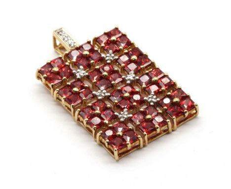 A 9ct gold ruby and diamond pendant, the rectangular pendant with square clusters of square step cut rubies, with eight cut d