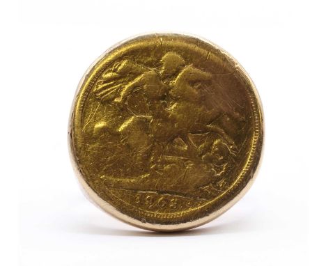 A gold sovereign ring, a 1963 sovereign hard soldered to a gold mount, with tapered shoulders and a plain shank, tested as ap