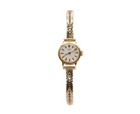 A ladies' gold Longines mechanical bracelet watch,17mm diameter case, with a silvered dial and black baton hour markers, 17 j