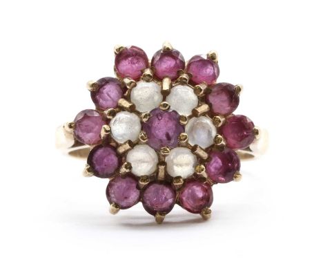 A 9ct gold ruby and moonstone target cluster ring,a round mixed cut ruby, to surround of round cabochon moonstones, and outer