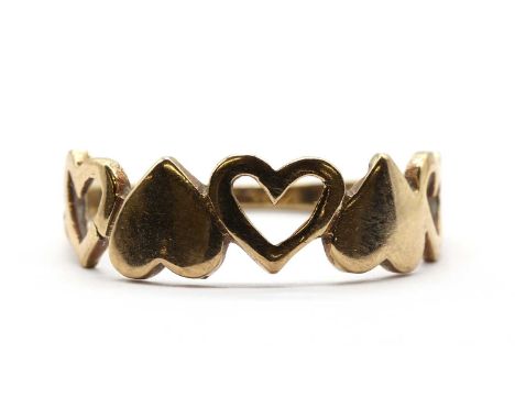 A 9ct gold dress ring, the head composed of alternating hearts and open hearts, to plain shank, Edinburgh 1987, 1.52g.Finger 