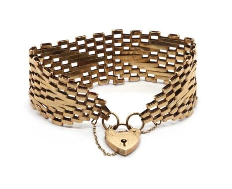 A 9ct gold gate bracelet, with elongated bars forming a chevron pattern, to heart shaped padlock clasp and safety chain, Lond