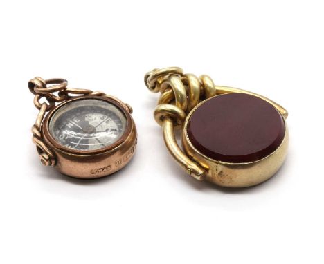 A 9ct gold swivel fob, with a compass to a glazed panel on one side, and a bloodstone plaque verso, to twisted wire mount and