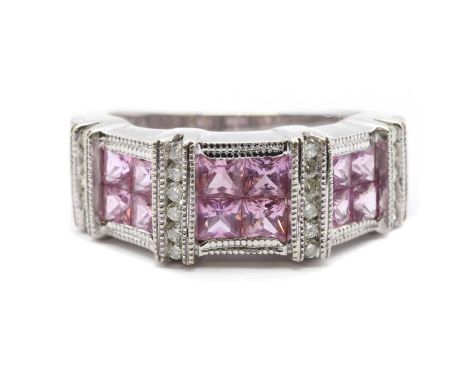 A 14ct white gold pink sapphire and diamond ring,with sets of four princess cut pink sapphires, set between raised bars, chan
