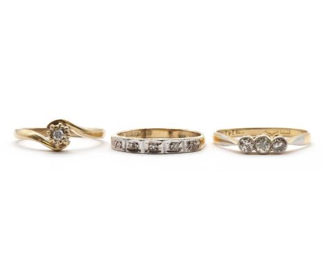 A three gold diamond set rings, comprising a 9ct gold single stone diamond ring, Birmingham 2000, millennium mark, a 9ct gold