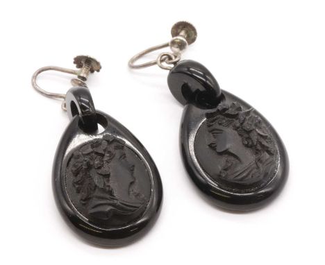 A pair of jet cameo drop earrings, carved jet cameos depicting female profiles, to teardrop shaped jet mounts and ring, to la
