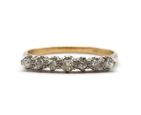 A gold seven stone old cut diamond ring, a row of old Swiss cut, eight cut and old European cut diamonds, claw set to a plain