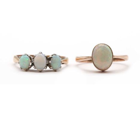 A 9ct gold single stone opal ring, an oval cabochon opal, rub set to tapering shoulders and a plain shank, Chester 1921, toge