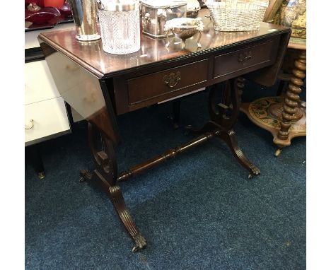 A reproduction mahogany sofa table with two drawers on lyre design supports.