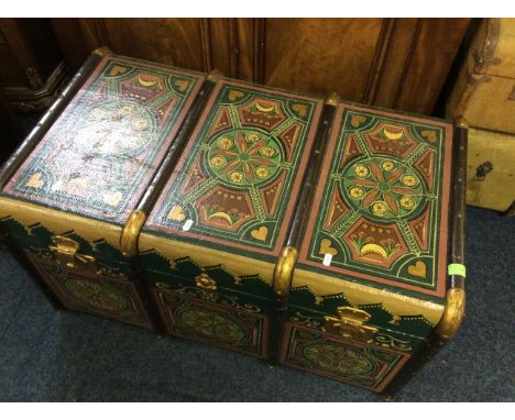 A wood bound travel trunk with pattern decoration on green background.
