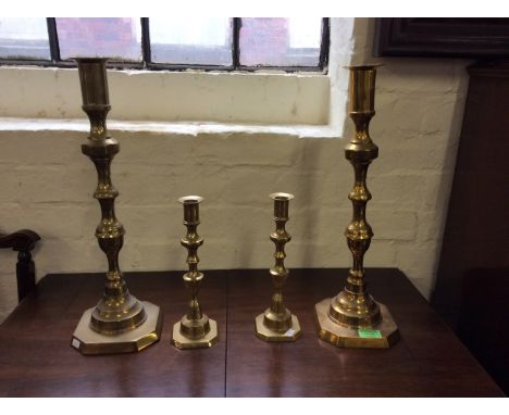 Two pairs of brass candlesticks, two large possibly altar candlestick holders.