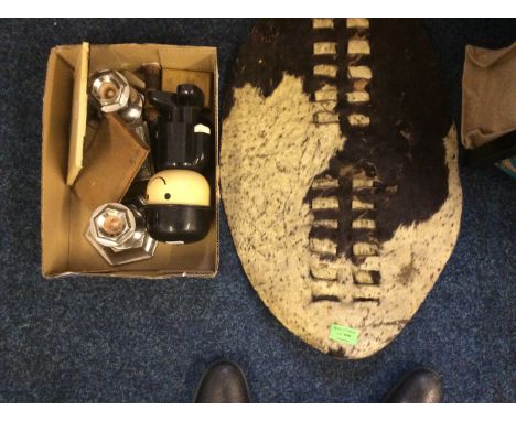 An African shield with a collection of brassware, cigarette case with lighter, a cork carving, candlesticks etc.